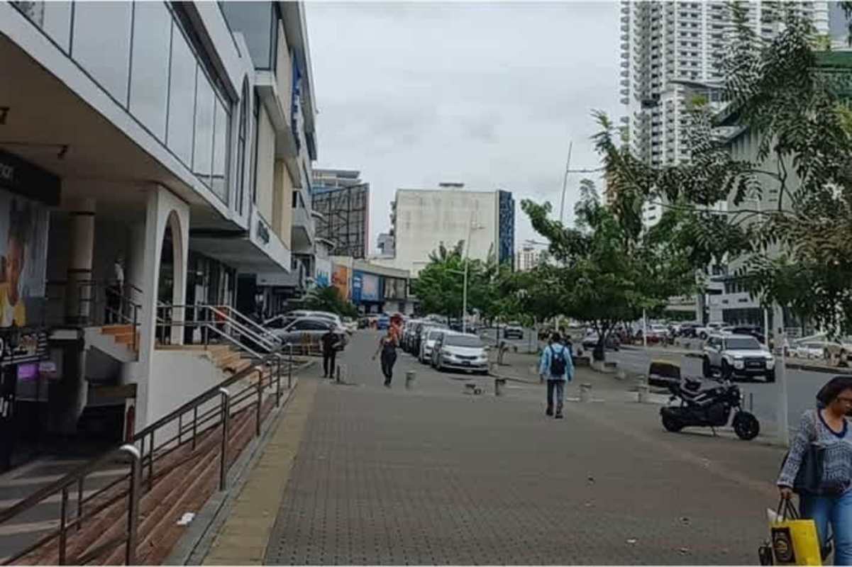 Street facing commercial building Plaza Concordia glass storefronts Panama City