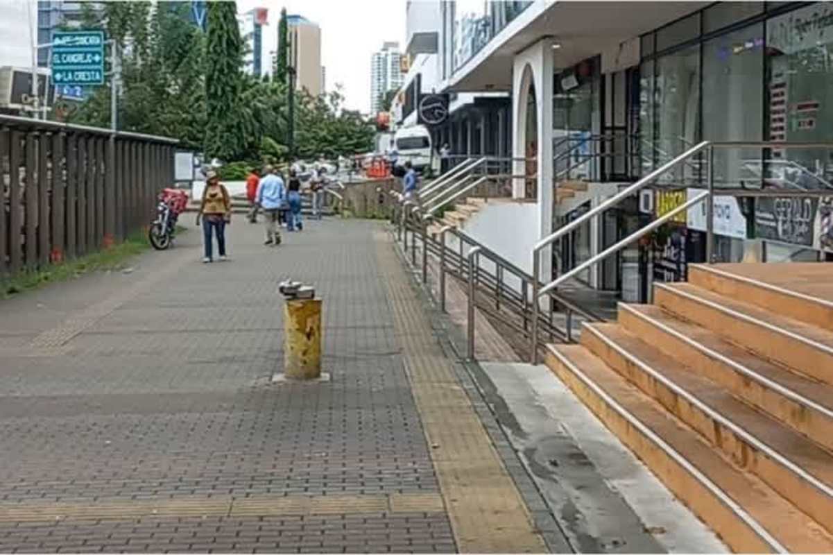Street view with stairs, shopfront glass, and pedestrian walkway Plaza Concordia Panama