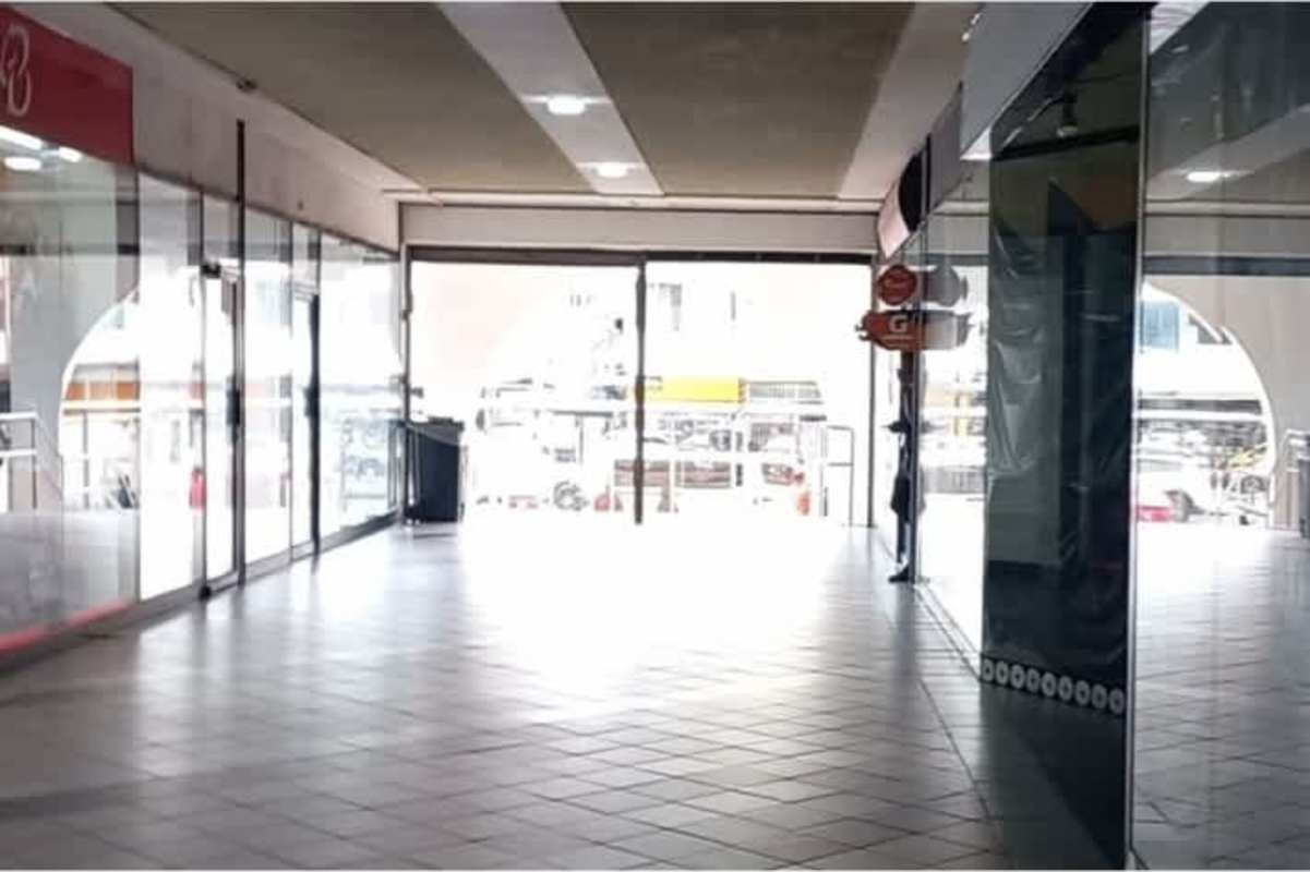 Interior view of shopping corridor with glass-fronted stores and tiled floor Plaza Concordia Bella Vista Panama