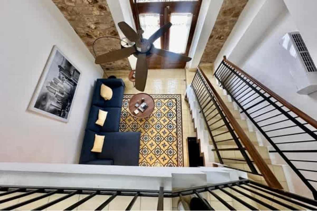 Modern kitchen with granite countertops, red cabinets, patterned tile floor PH Casa Panamá Casco Viejo