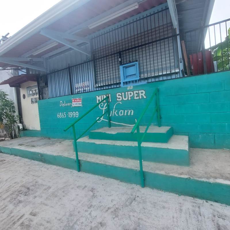 Interior industrial container space with metal shelving fluorescent lights and glass display refrigeration unit, Nuevo Tocumen Panama