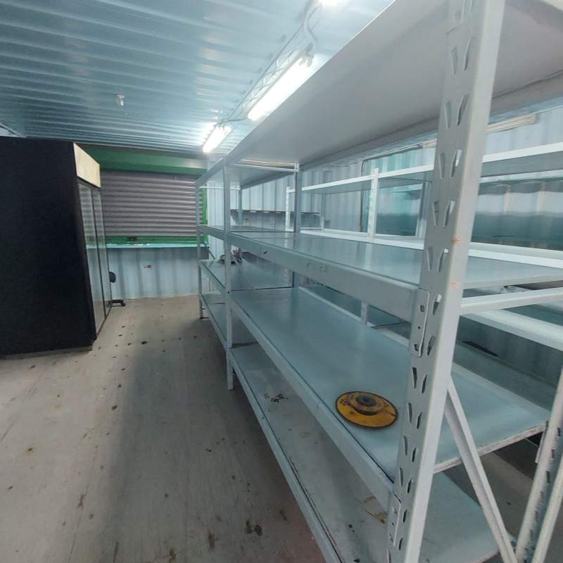 Interior container retail unit with metal shelving fluorescent lighting and refrigerator, Nuevo Tocumen Panama real estate
