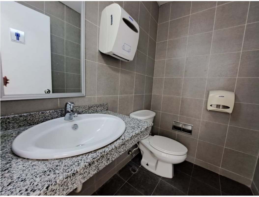 Corporate restroom with granite counter sink and wall mirror at Torre Las Américas