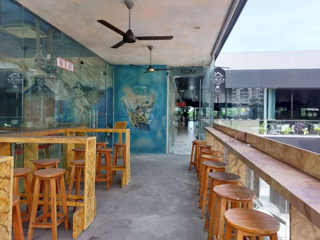 Modern dining area with glass walls, blue artistic ceiling, wood finishes at PH BICSA Financial Center Panama City