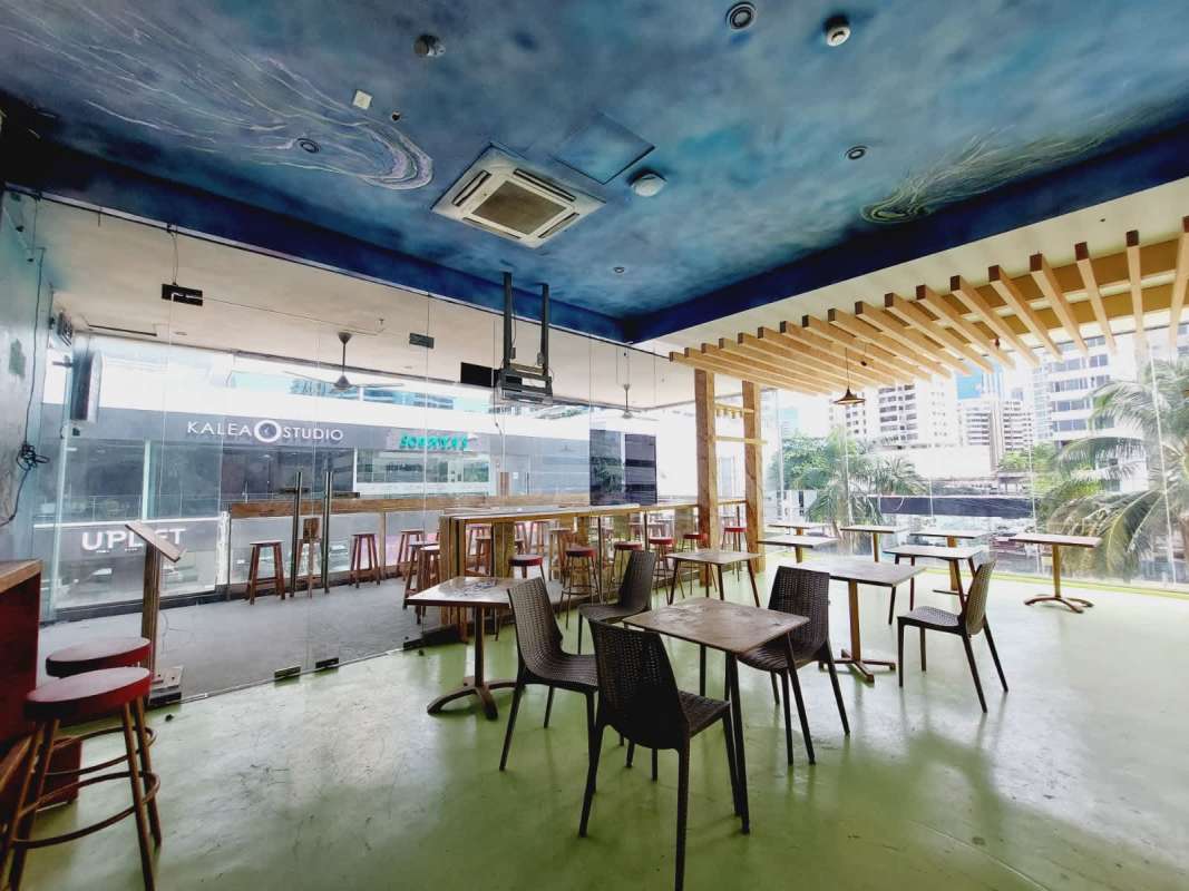 Rooftop terrace with wood furniture, glass rail, city views at PH BICSA Financial Center Panama City