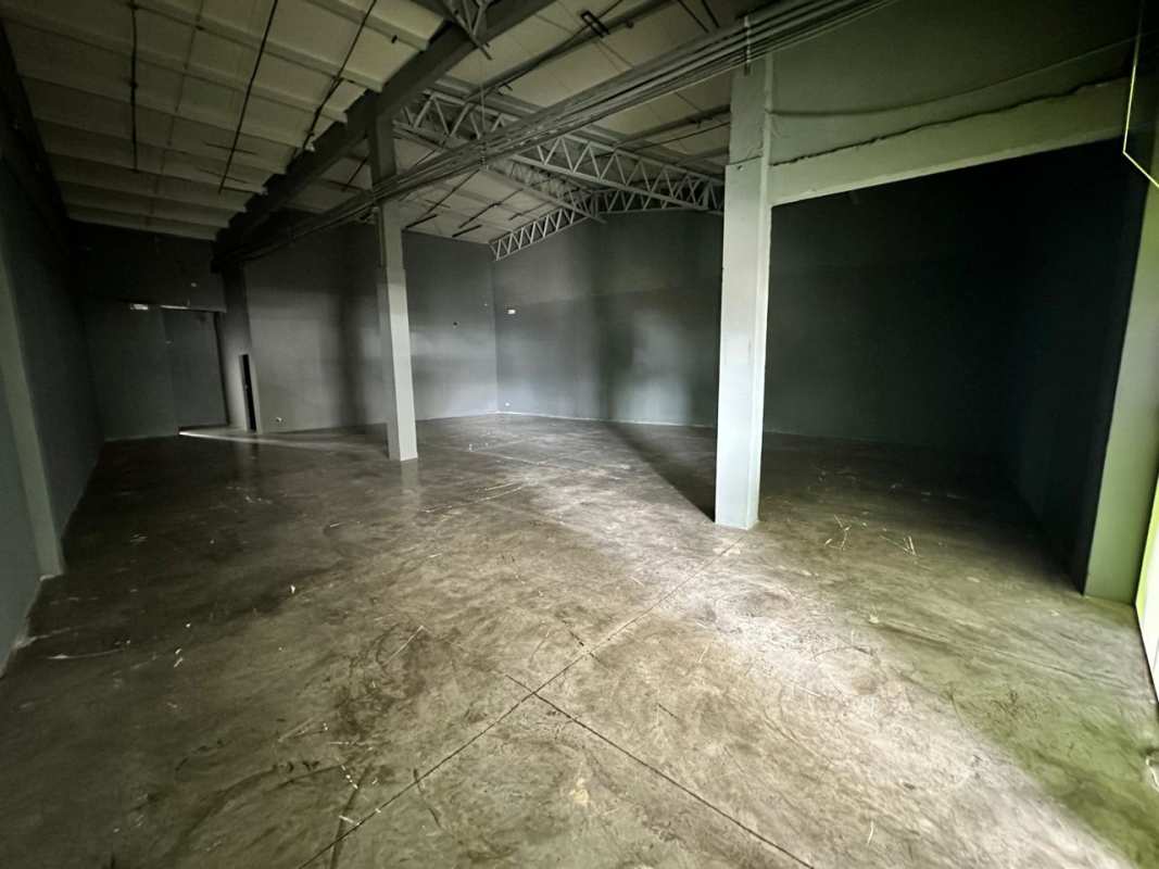 Empty commercial unit with exposed ceiling beams and concrete floors at City Plaza El Dorado Panama