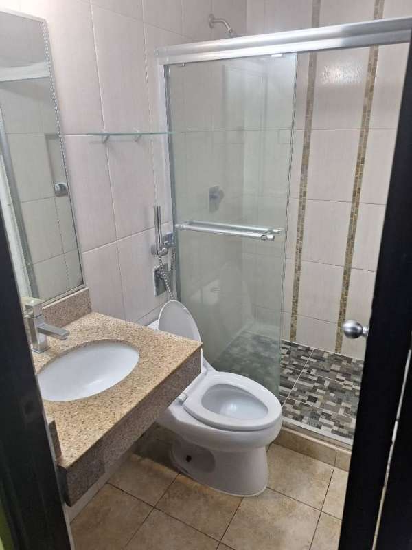 Contemporary bathroom with glass shower enclosure, granite countertop, modern fixtures in PH Cosmopolitan Park.