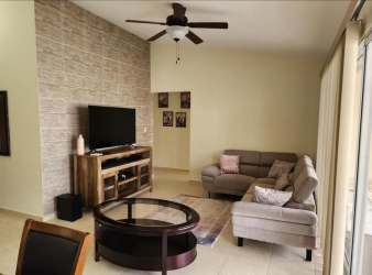 Contemporary living room with sectional sofa, stone wall, AC and sliding doors in Costa Verde Panama