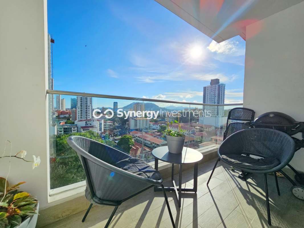 Bright furnished living room with large sliding windows in Bella Vista Park tower Panama City