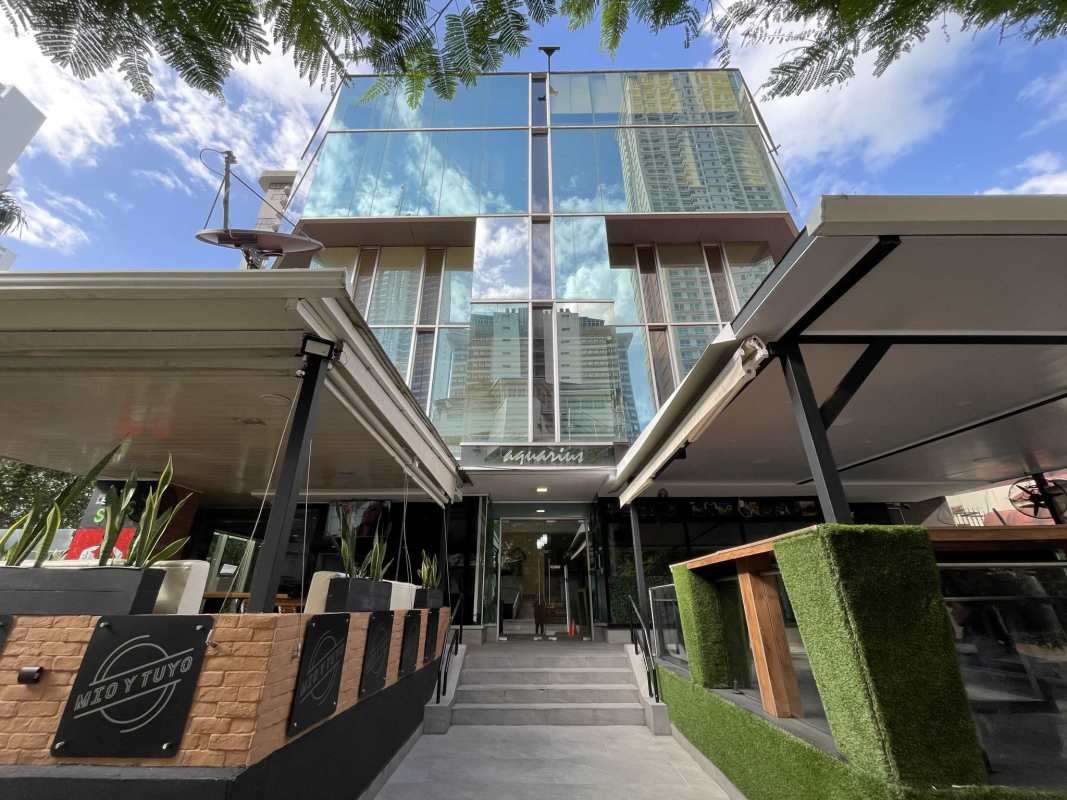 Contemporary commercial property with glass facade and outdoor seating PH Aquarius Panama City