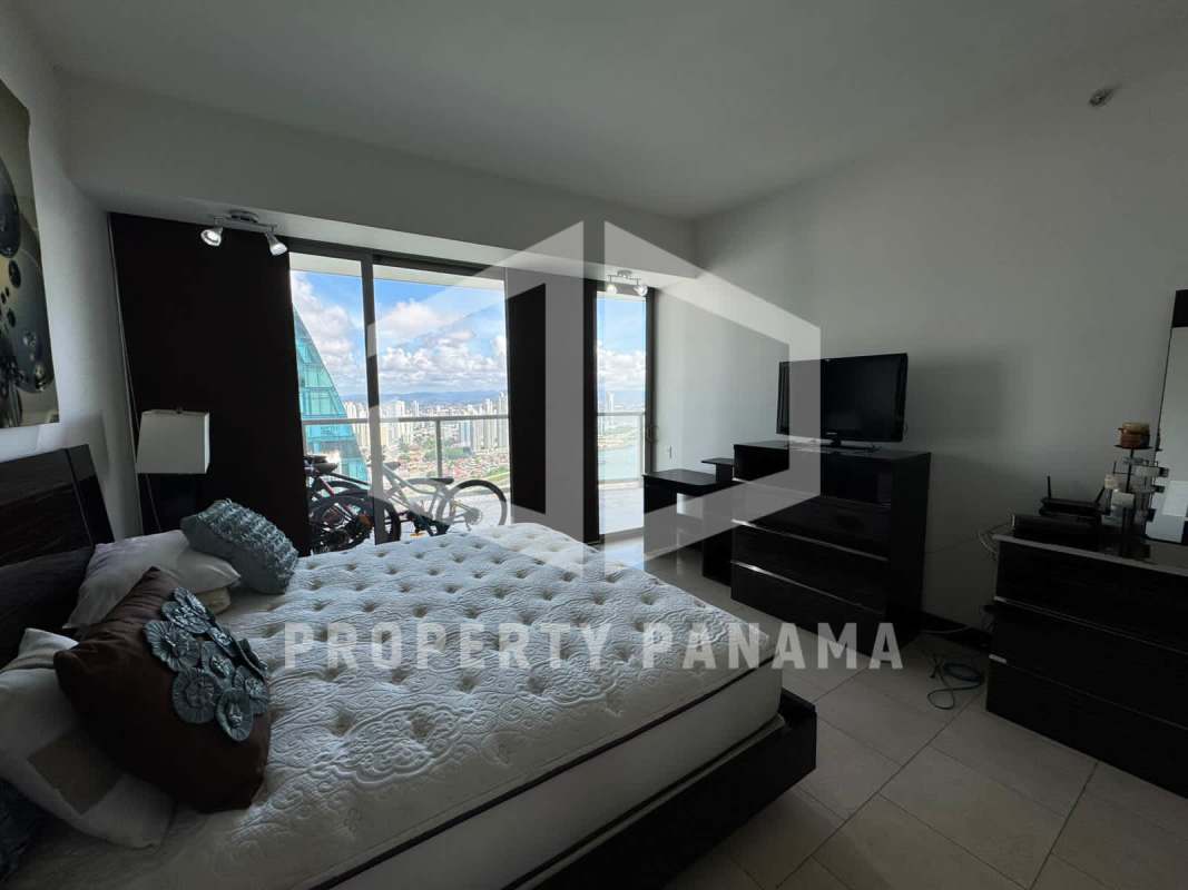 Bright bedroom with large windows showcasing the Panama City skyline at PH The Ocean Club