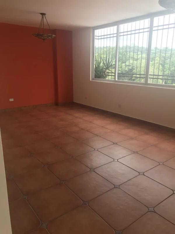 Bedroom with dark wardrobes tile flooring high ceiling Villa de las Fuentes Panama