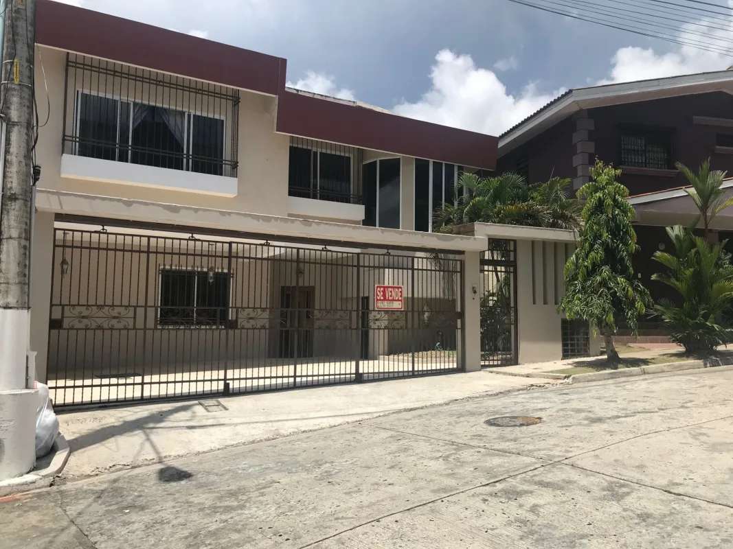 Spacious bedroom with blue accent wall ceiling fan tile floors Villa de las Fuentes Panama