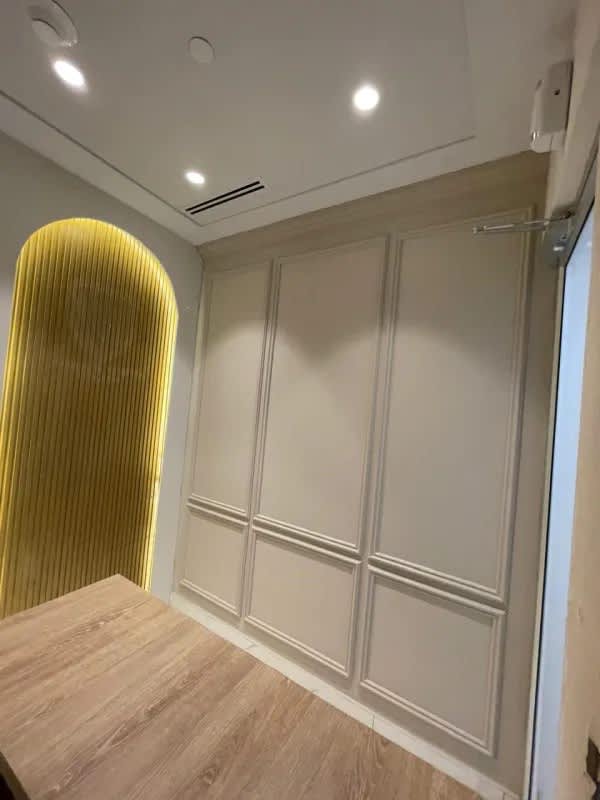 Modern kitchenette in commercial office Punta Pacifica with marble counter and beige cabinets