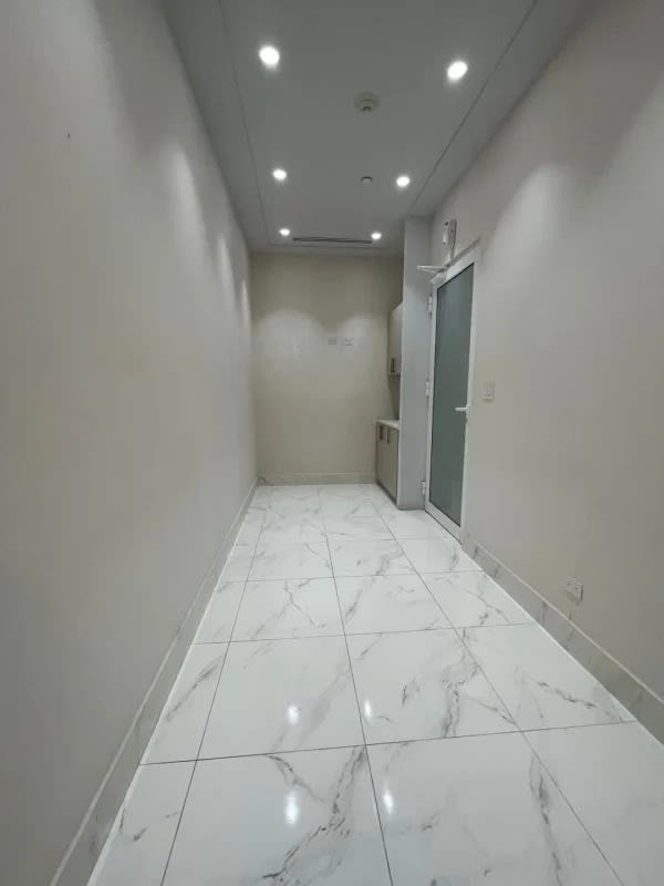 Bright hallway with marble floor and glass door inside Punta Pacifica Town Center office space
