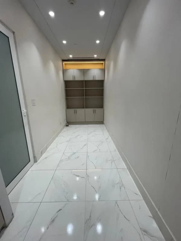 Modern hallway with marble tile flooring, built-in cabinets at Town Center Punta Pacifica Panama office