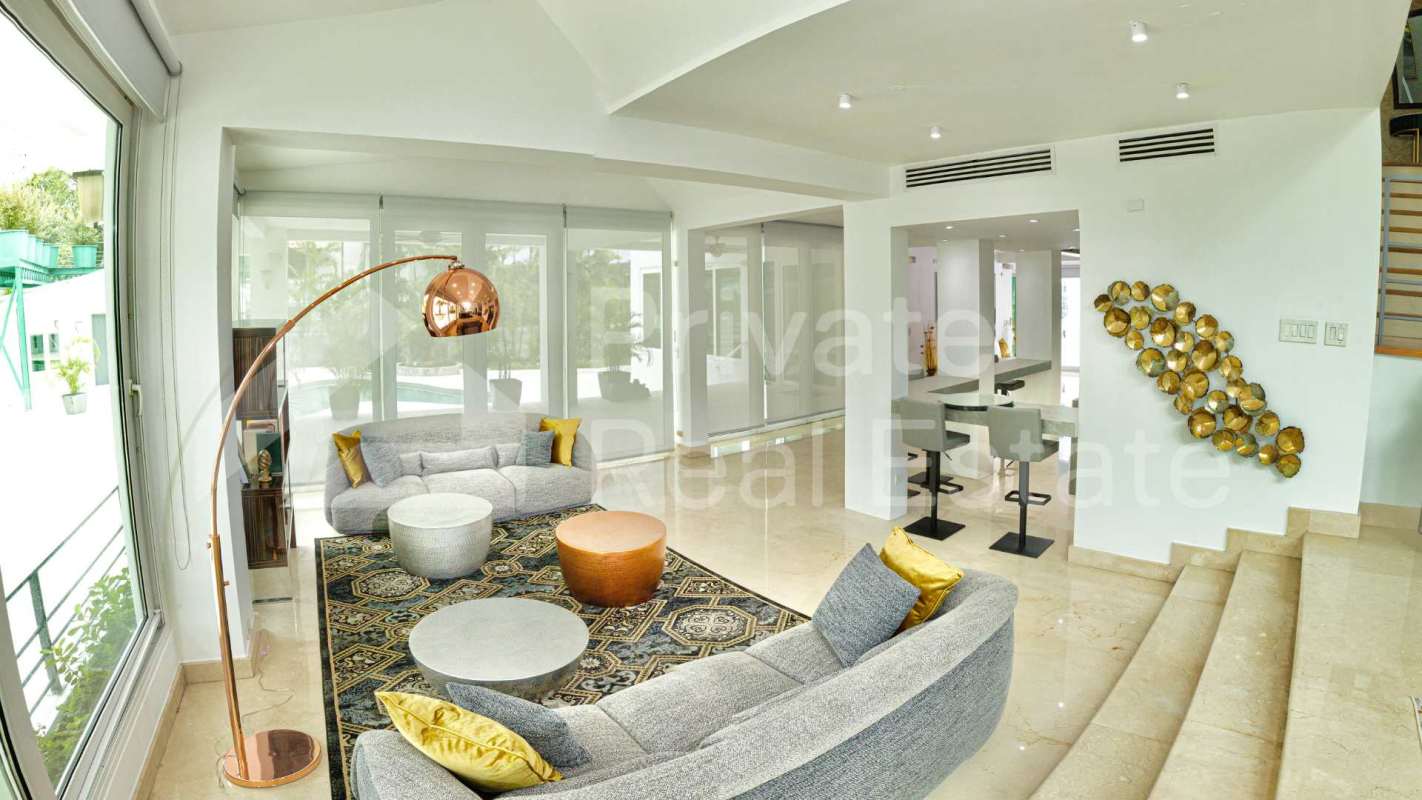 Spacious living room in luxury mansion Altos del Golf with marble floors and vaulted ceiling