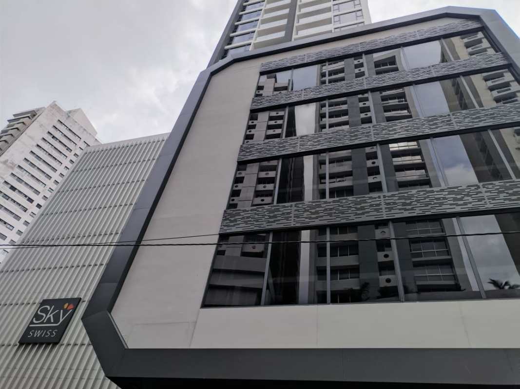 High-rise condominium PH Sky Swiss with modern glass facade and signage in El Cangrejo Panama City