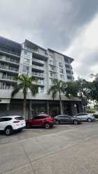 Bright open living room with large windows and balcony access at PH Mosaic Panama Pacifico
