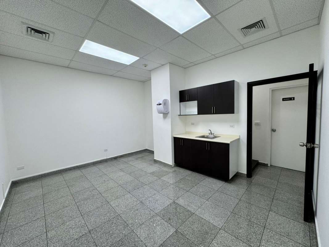 Kitchenette kitchen area in commercial office PH BICSA Tower with tile flooring cabinets and sink