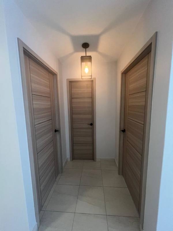 Bright hallway with wood doors white walls PH San Francisco City Panama apartment rental
