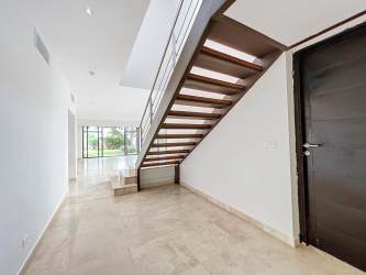 Modern entryway with floating stairs, marble tiles, and open layout in PH Nativa