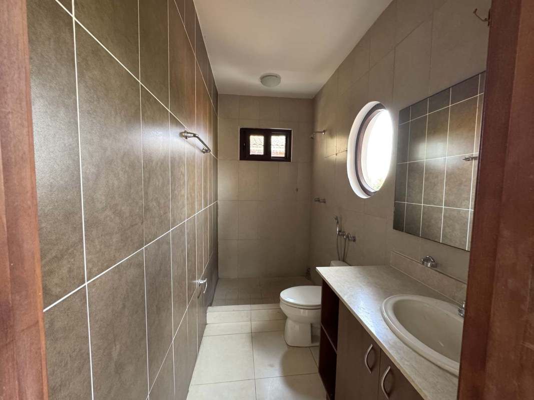 Spacious walk-in closet with built-in wooden shelves in Costa Sur Panama home