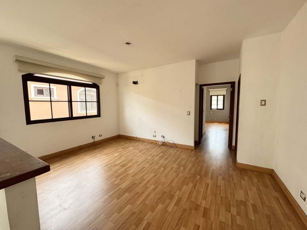 Bedroom with built-in wooden wardrobe, large windows, and air conditioning mount in Costa Sur home