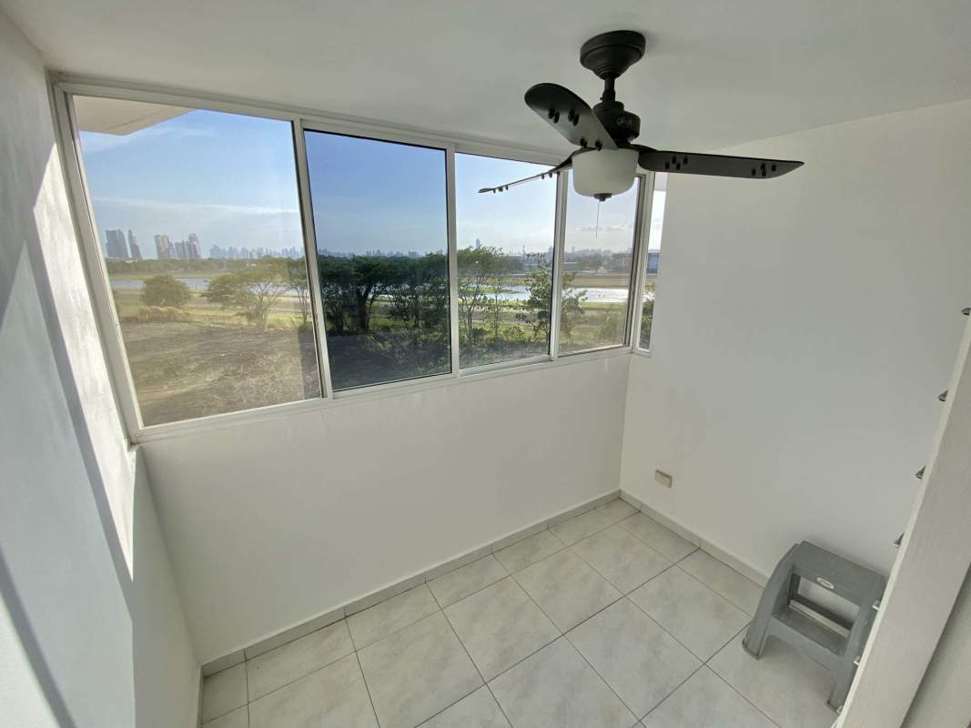 Bedroom featuring built-in wardrobe air conditioning mirror and tiled floor in Llano Bonito Park Panama