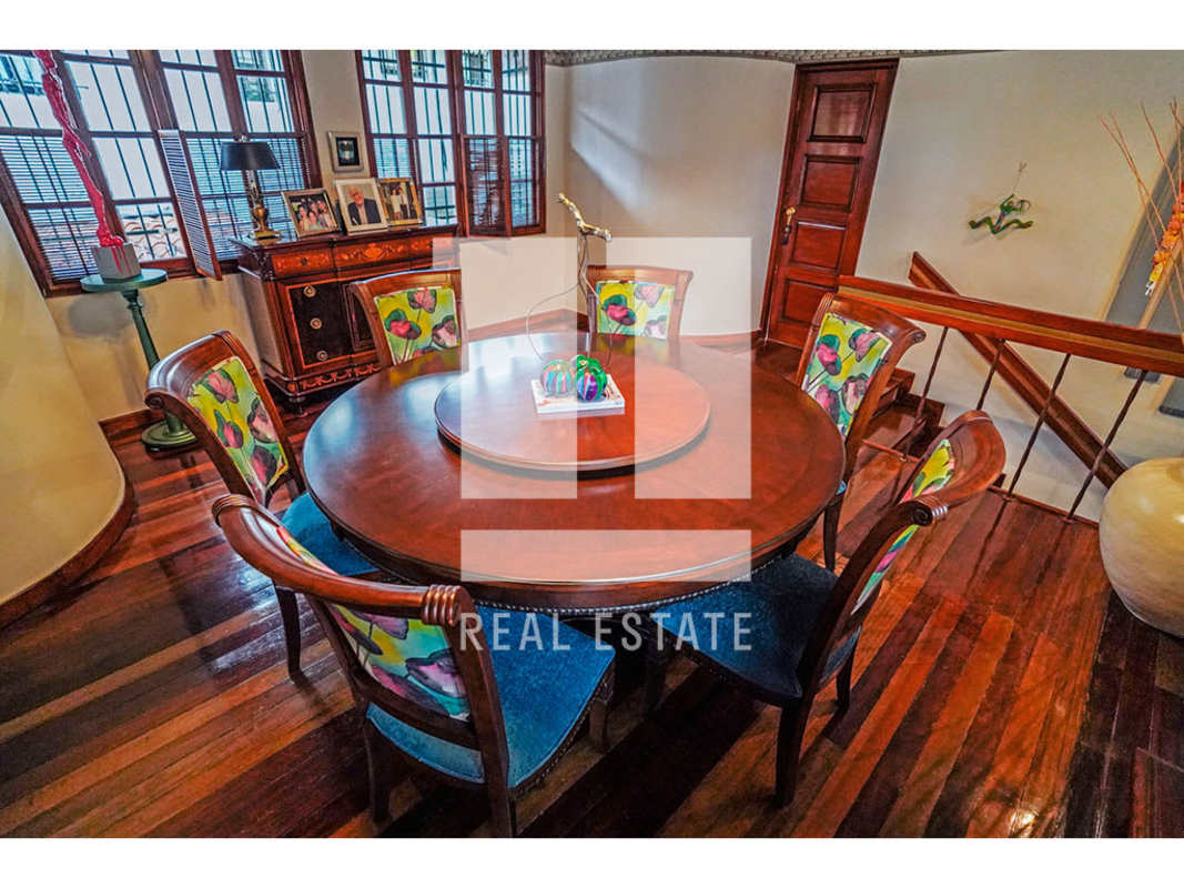 Kitchen with solid wood cabinetry, decorative tile backsplash and terracotta floor in La Alameda Panama