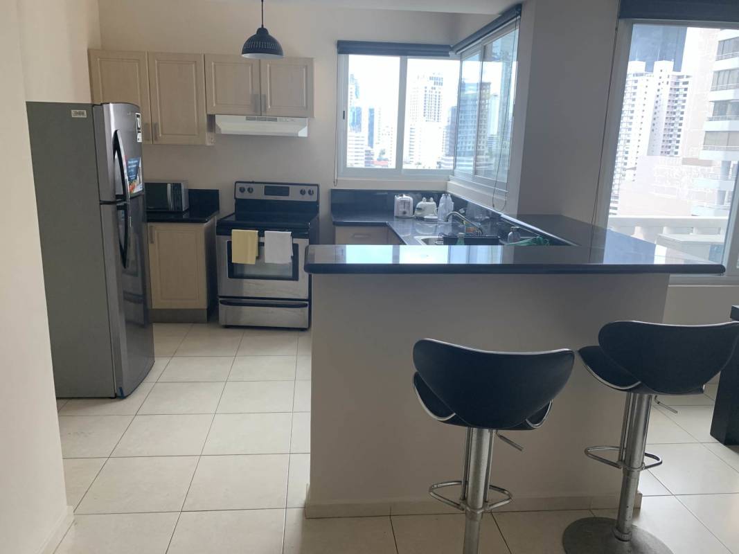 Spacious master bedroom with large window and city skyline ocean view in PH Vista del Mar Panama