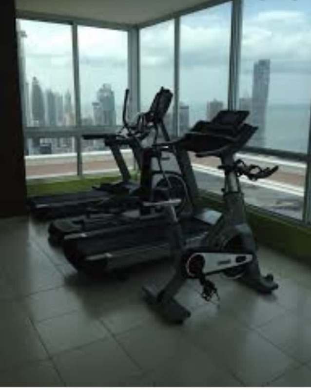 Fitness center with modern equipment and ocean skyline views in PH Vista del Mar Panama City