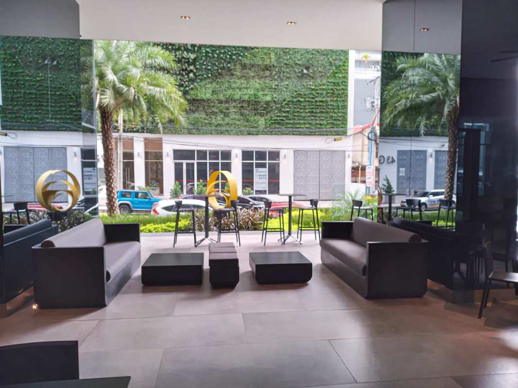 Lobby area with modern seating large glass pane and greenery view Nouvo Armani Plaza Bella Vista Panama