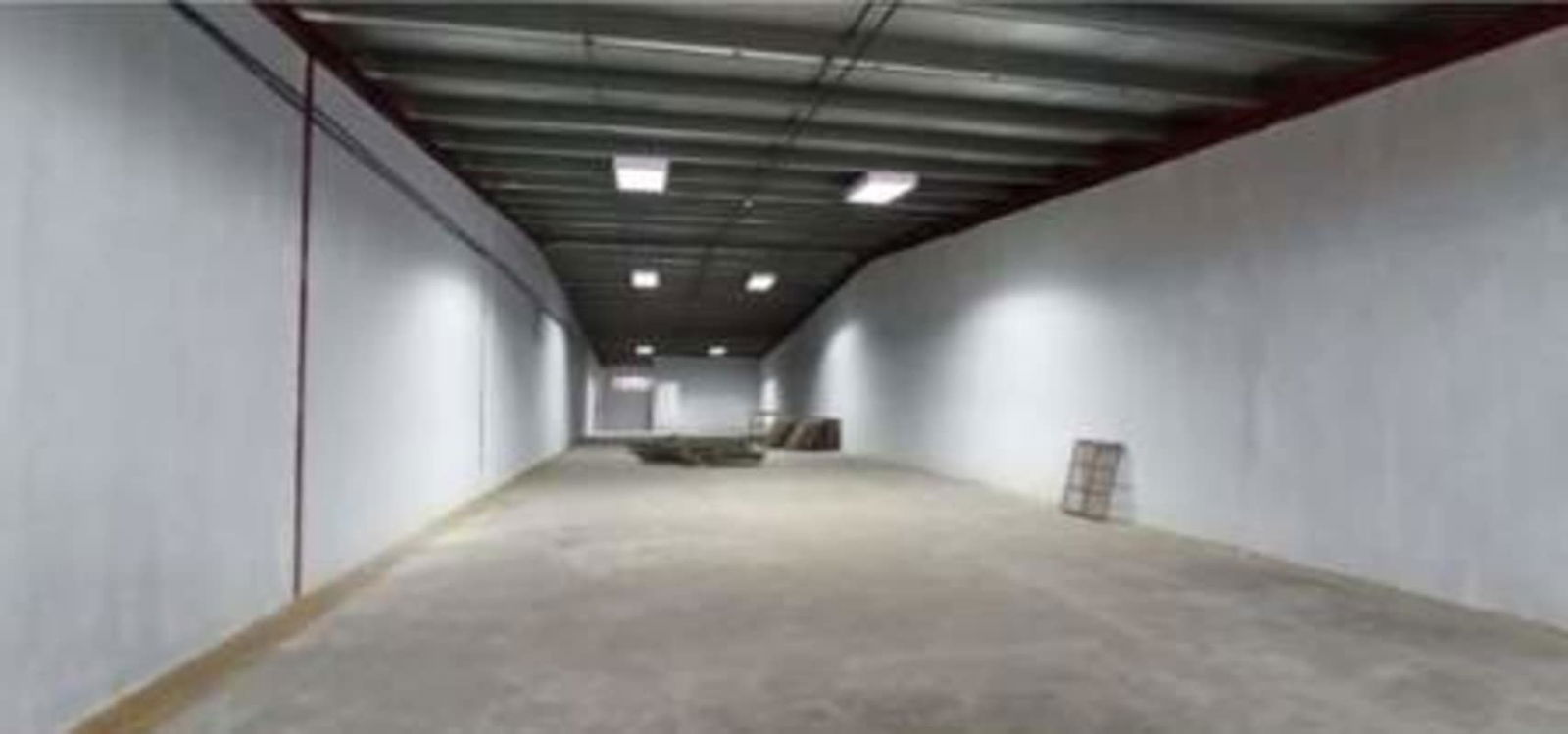 Empty warehouse interior with metal roof high ceiling concrete flooring in Panama