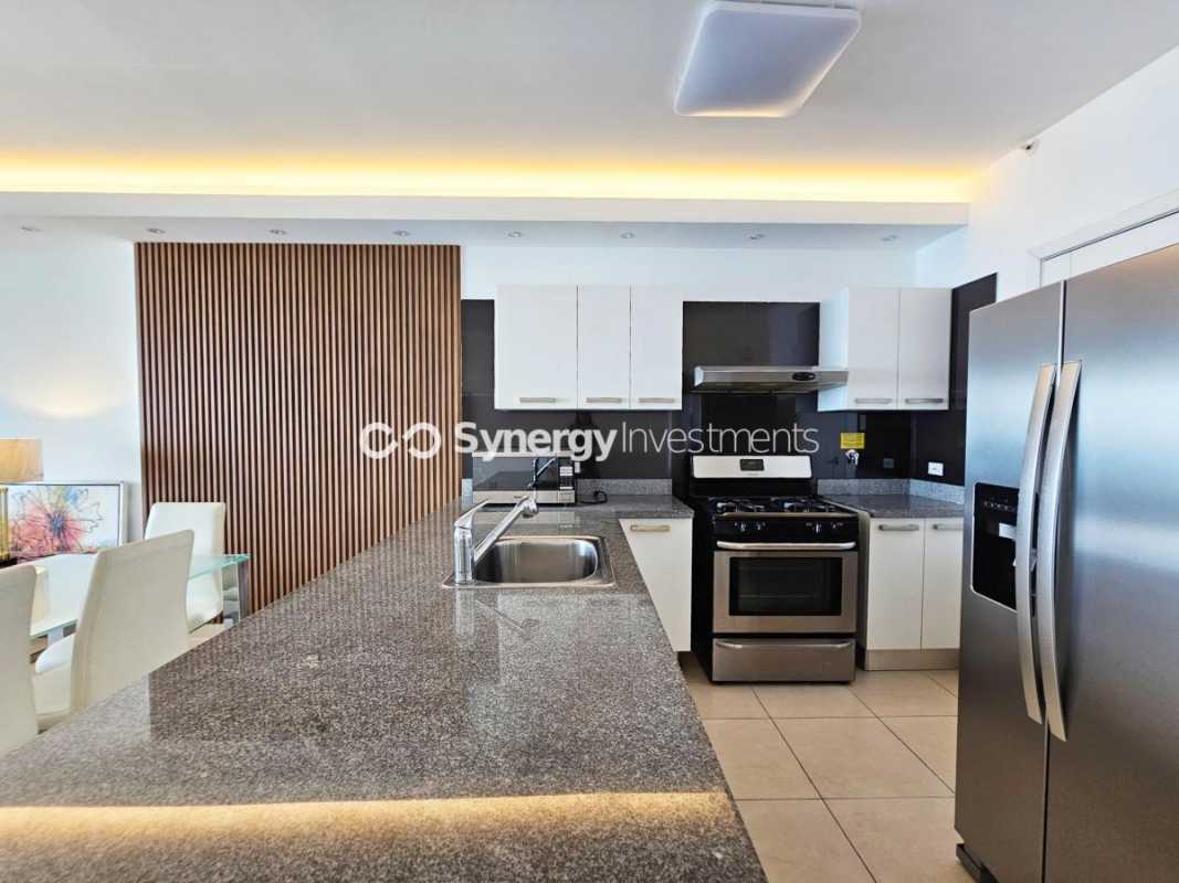 Fully equipped granite countertop kitchen with appliances inside PH BICSA Tower luxury apartment