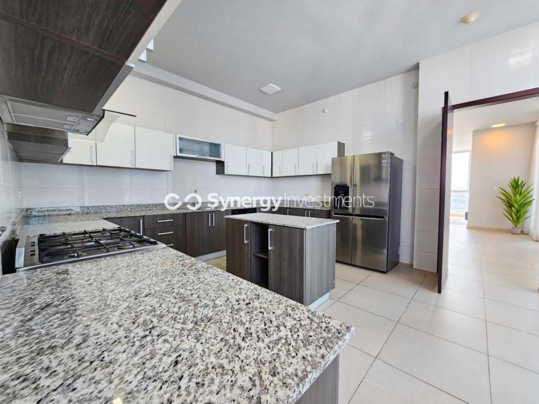 Granite countertop kitchen with large island and full appliances in luxury duplex PH Celeste Costa del Este Panama