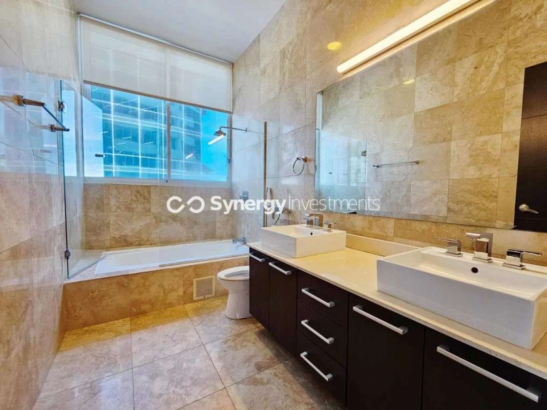 Contemporary bathroom with glass shower, marble finishes and double sinks PH Celeste Costa del Este Panama