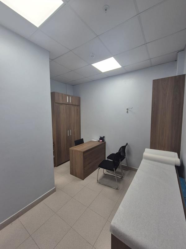 Reception waiting space furnished with cabinetry, tile flooring inside Pacific Salud Tower medical office