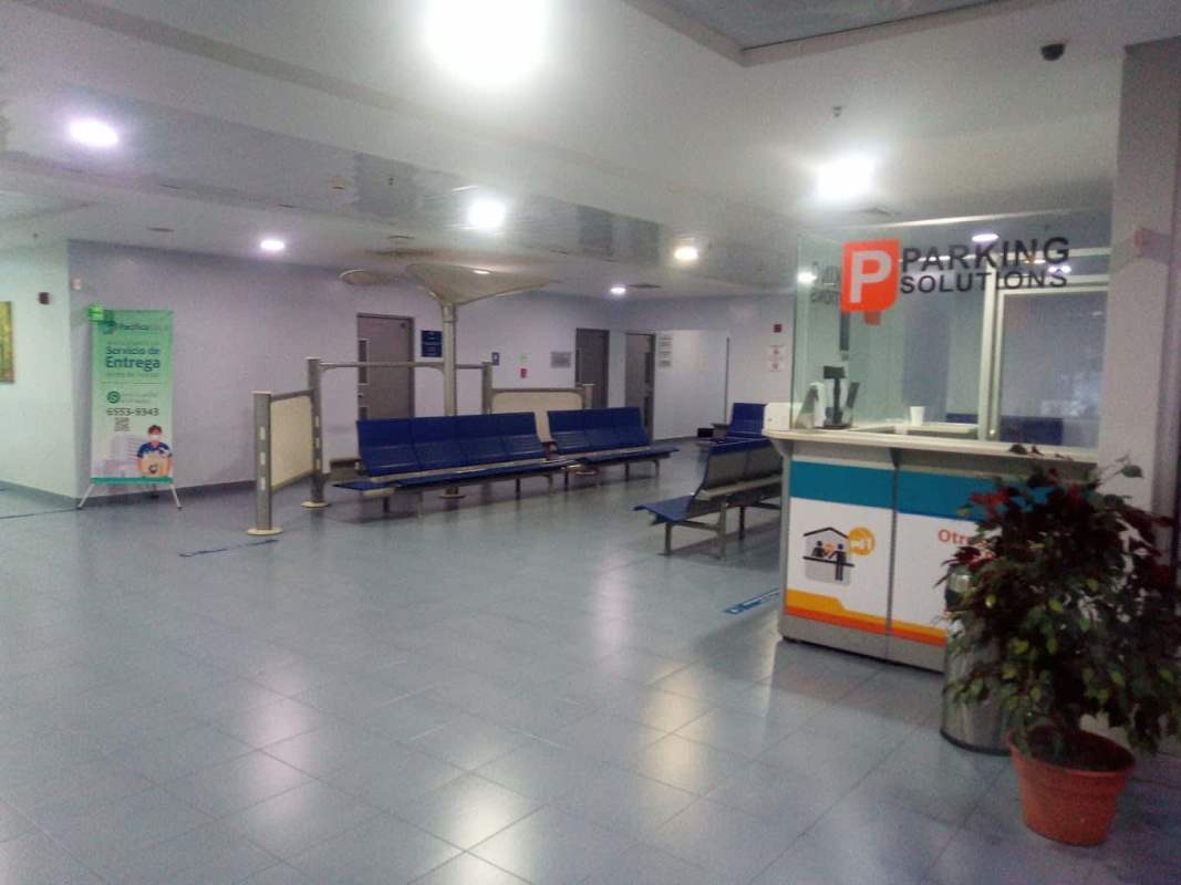 Building lobby with Parking Solutions counter and seating inside hospital tower Panama