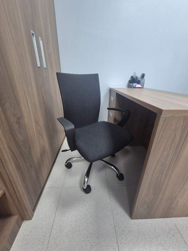 Home office style workspace with L-shaped desk in hospital commercial unit Panama