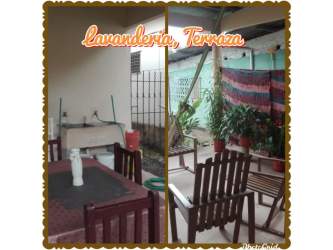 Outdoor covered terrace with laundry sink and seating area in central Chitré property