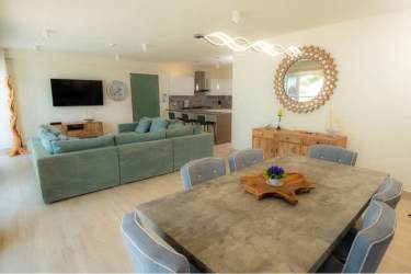 Spacious open living room and dining with large windows and ocean view PH Olas del Mar Playa Caracol