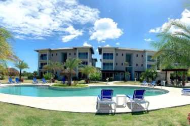 Contemporary beach resort pool with palms and tropical landscaping at PH Aires del Mar Panama