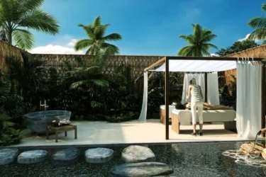 Modern gym overlooking tropical beach with panoramic ocean views at PH Surfside Playa Caracol