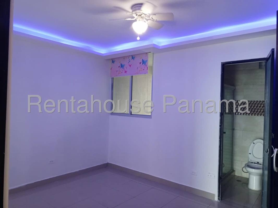 Bedroom with city views, closet, ceiling fan and large window PH Serenity at the Bay Panama