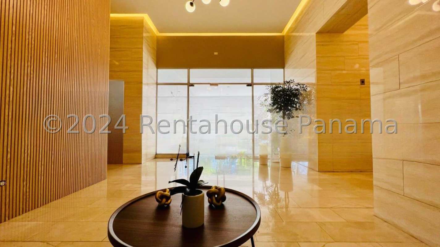 Modern apartment kitchen with glass cabinets, stainless appliances and large window at PH Serenity Panama