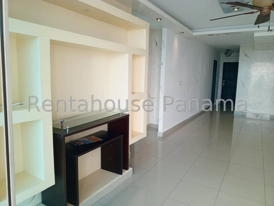 Open plan kitchen with glass-front cabinets, double sink, dishwasher, large window in Serenity at the Bay apartment