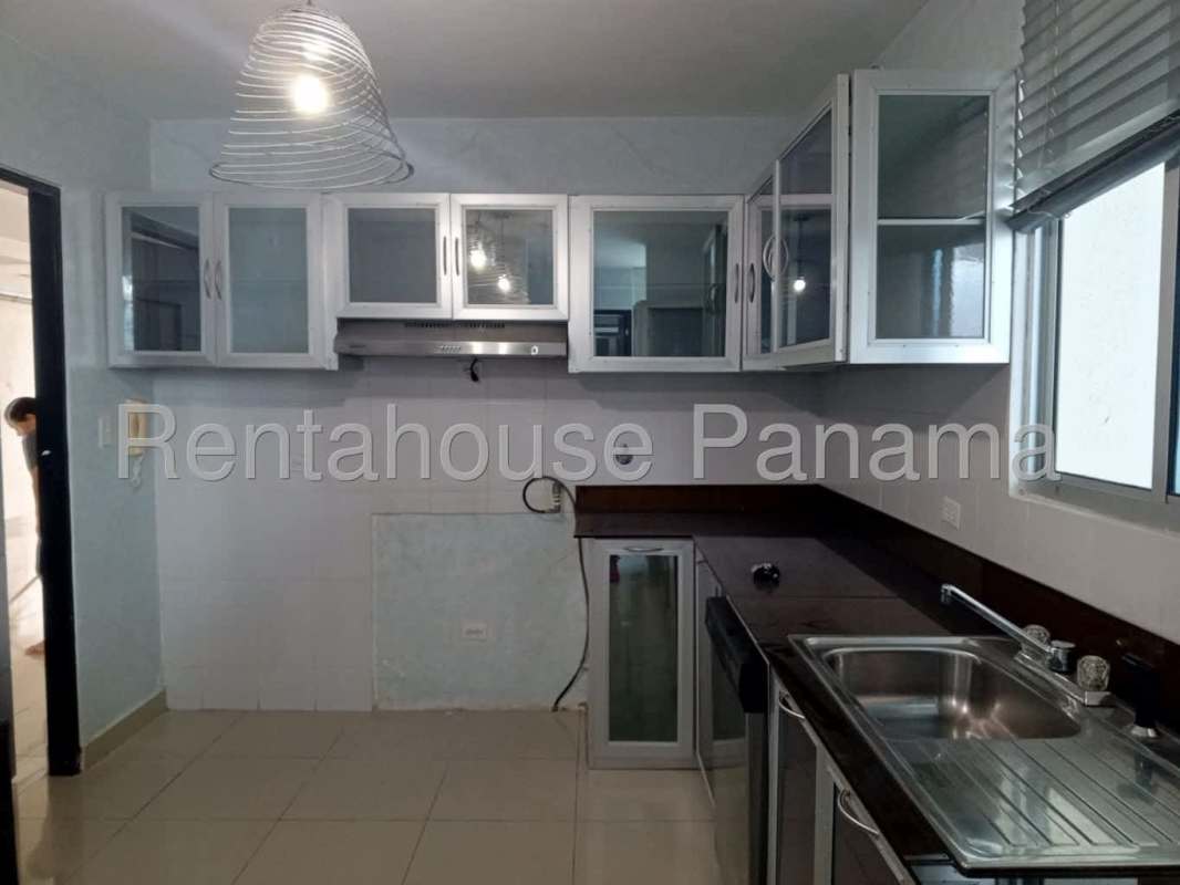 Bedroom with pink valance, blue LED lighting, tiled floors and ensuite bathroom in Serenity at the Bay Panama