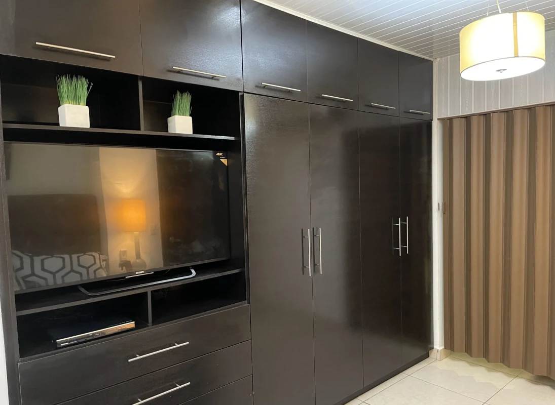 Modern bathroom furnished with stone countertops and glass shower PH BICSA Panama City