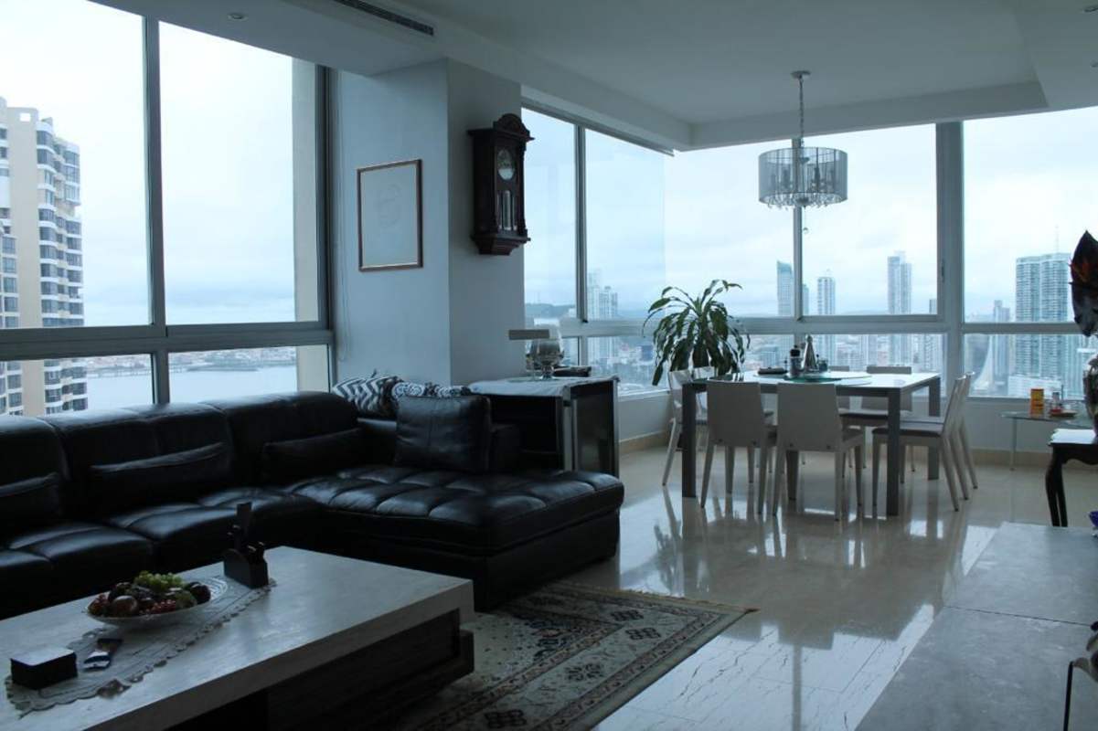 Modern living dining area with city and ocean views, marble floors, elegant décor in PH The Point Paitilla Panama